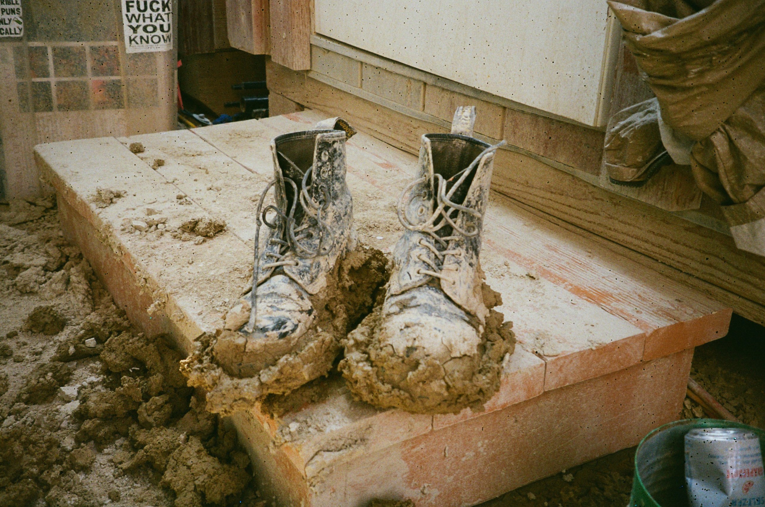 Mud-caked boots on a plank step