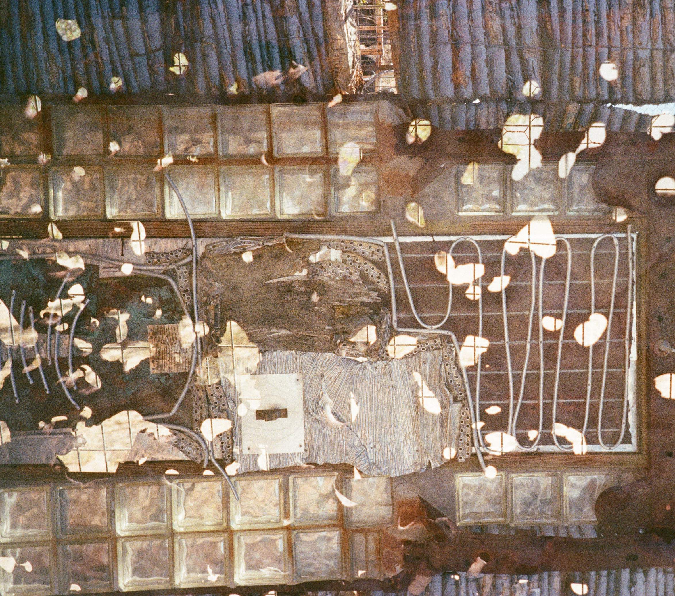 Assemblage of glass blocks, wood and rusted metal in a warm sepia tone