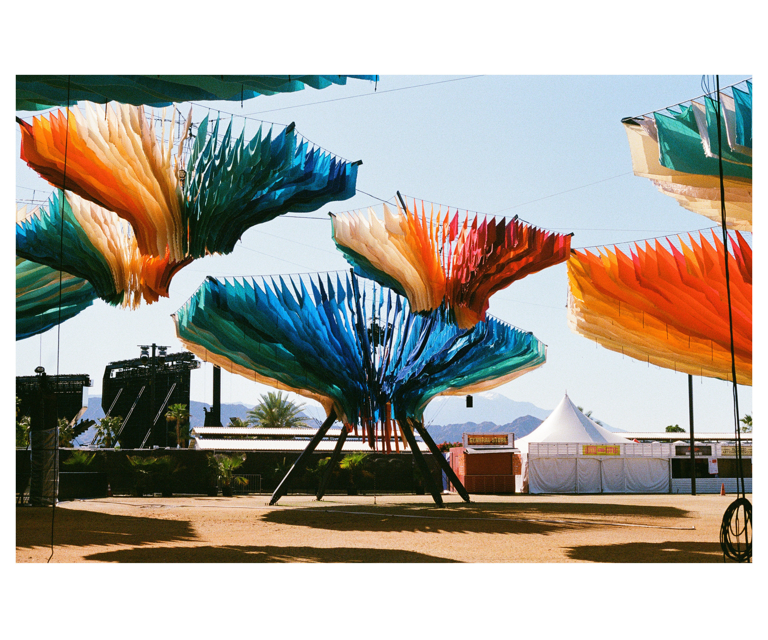 Fabric canopies on angled steel legs over the festival grounds