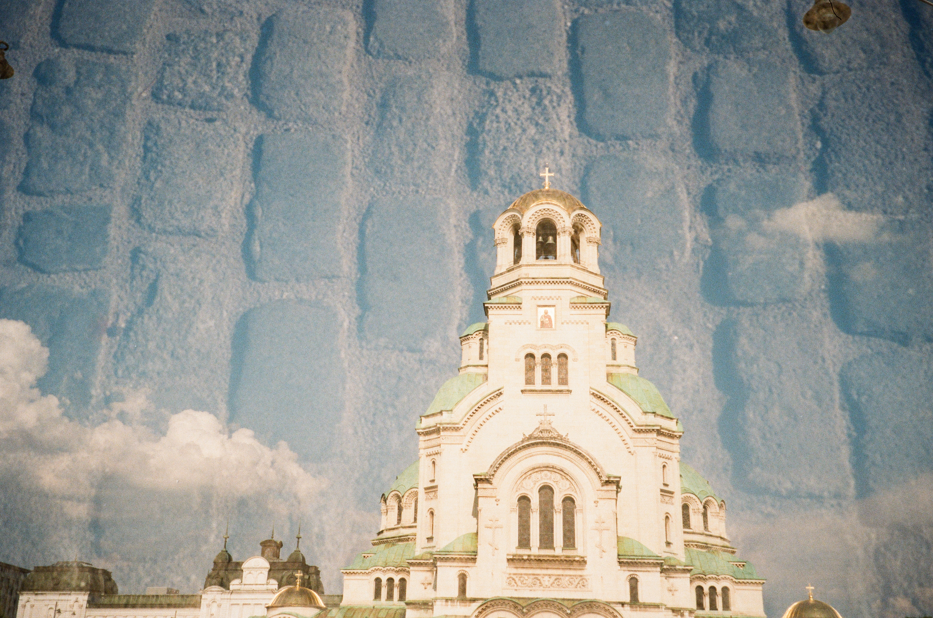 Golden-domed cathedral above reflected cobblestones