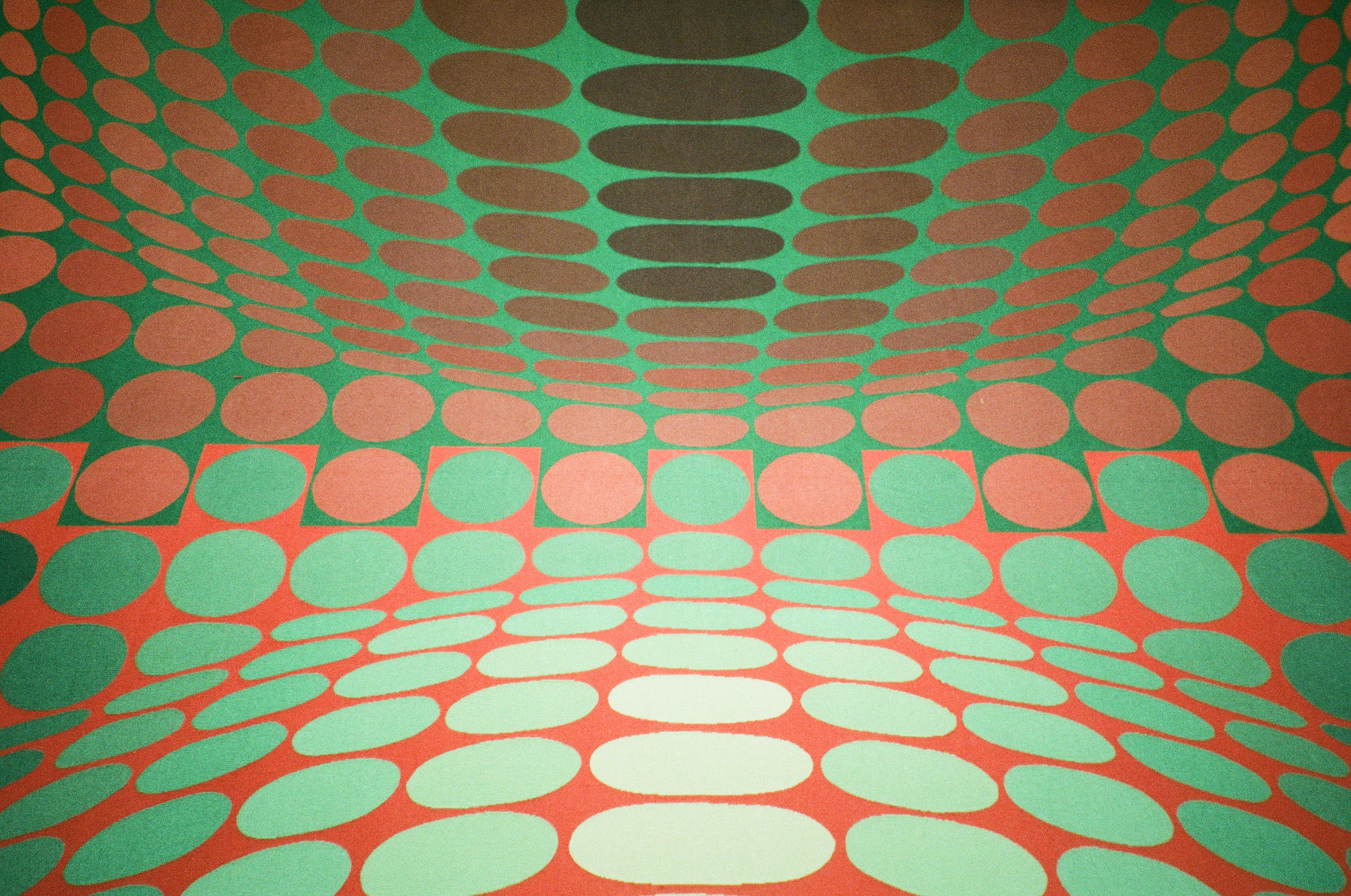 Op-art pattern of green and orange ovals