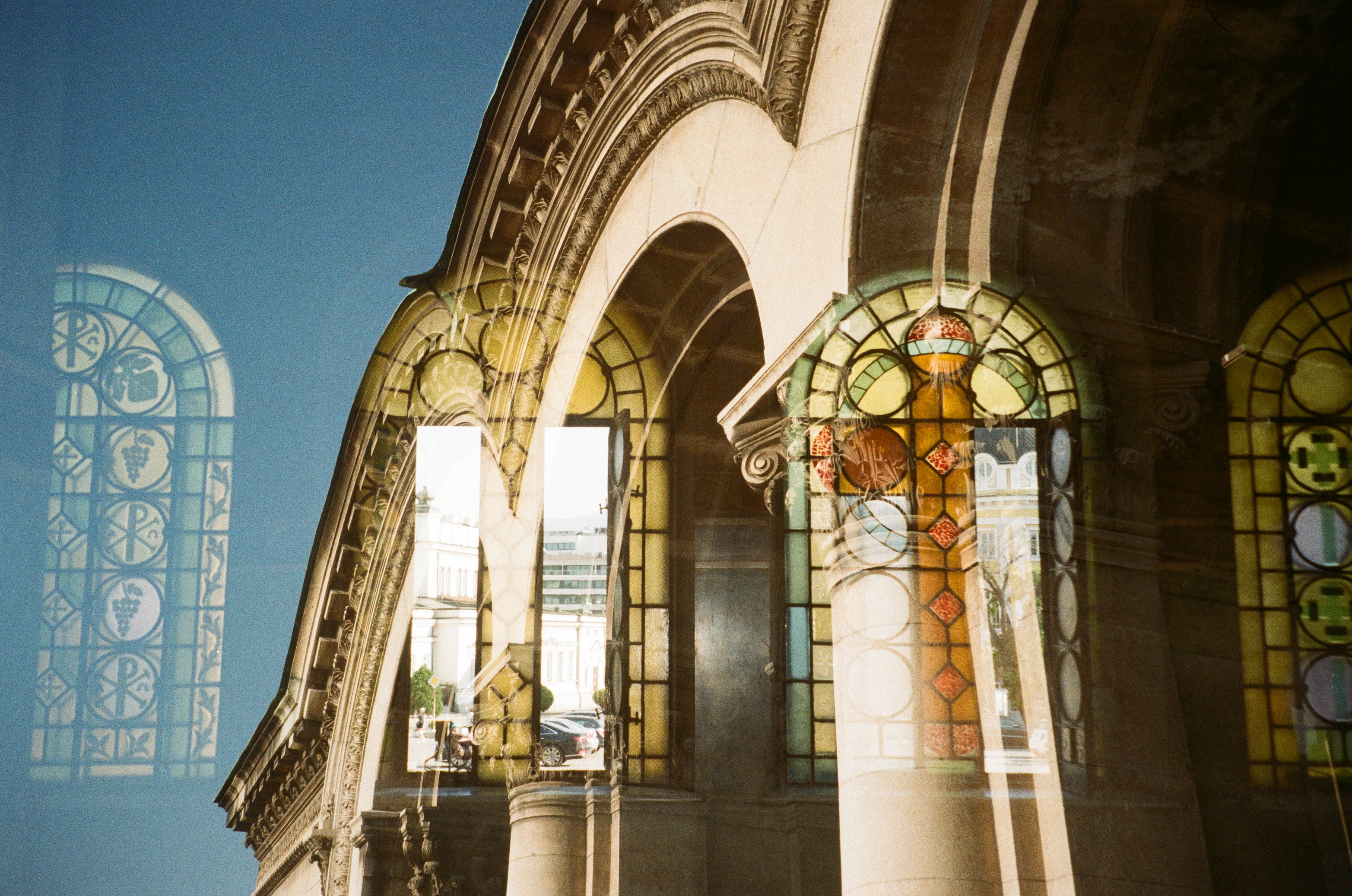 Double exposure of arched stained-glass windows