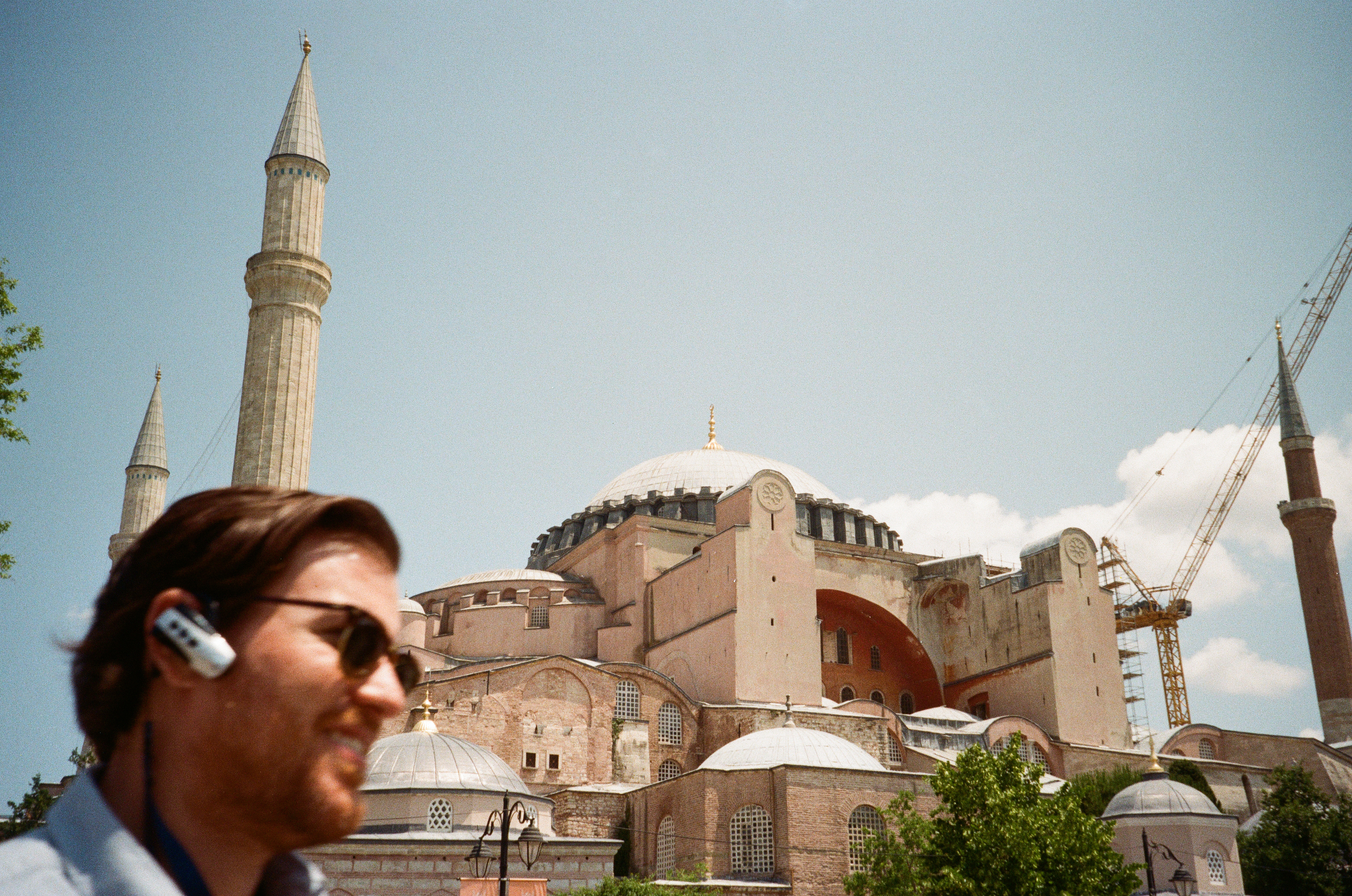 Hagia Sophia with a smiling man in sunglasses in the foreground