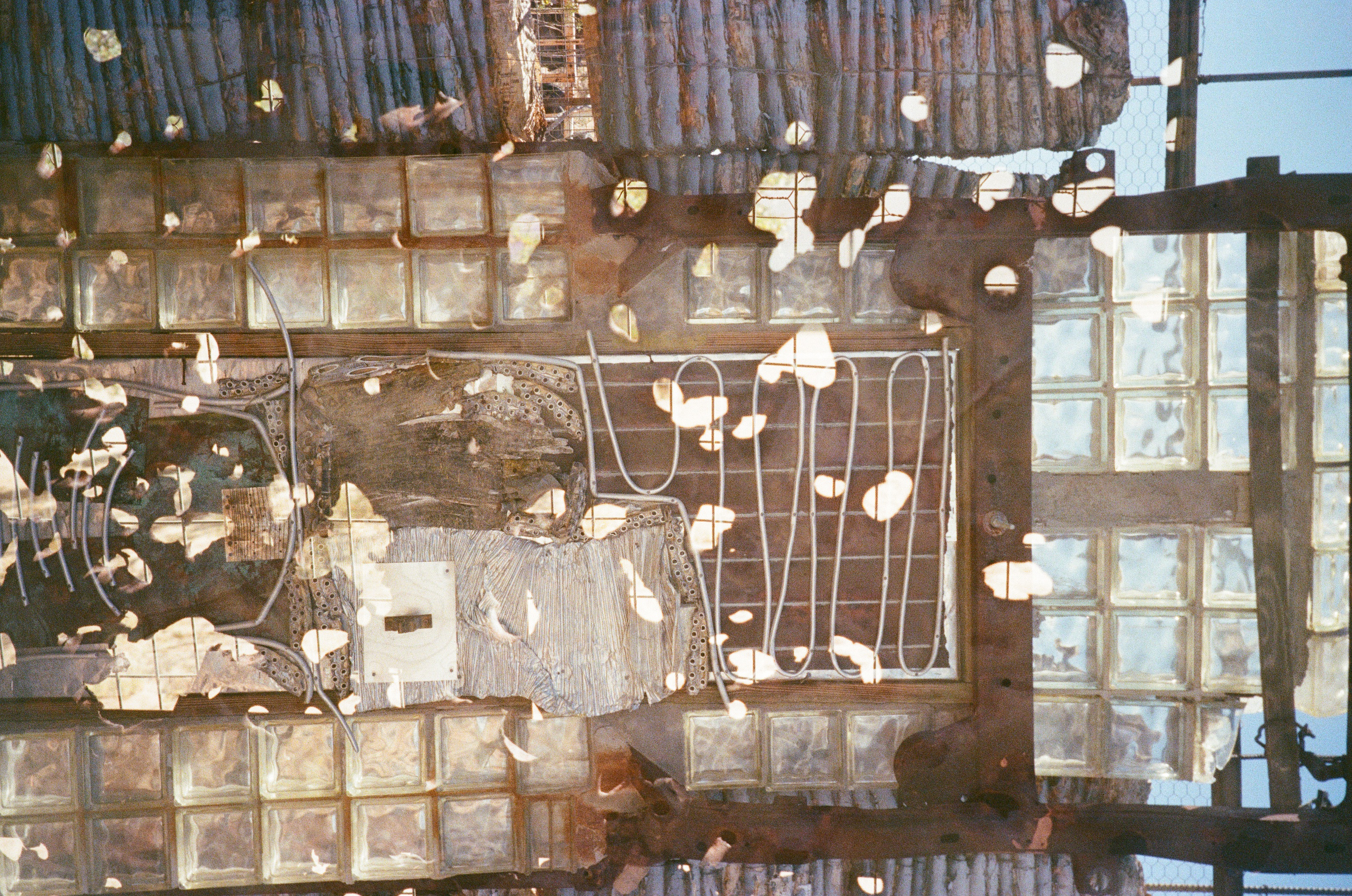 Assemblage of glass blocks, wood and rusted metal