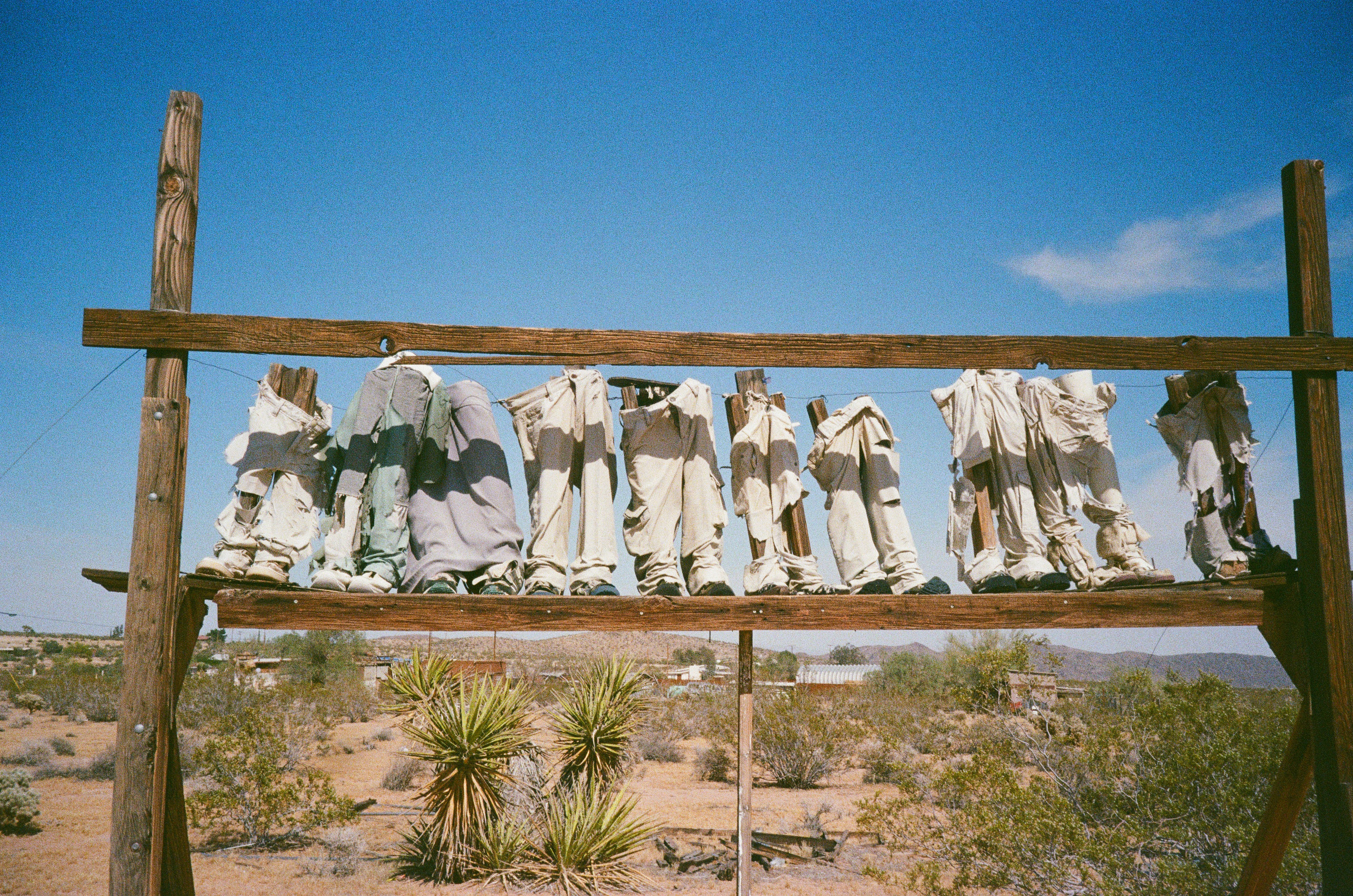 Trousers hung on a wooden frame in the desert