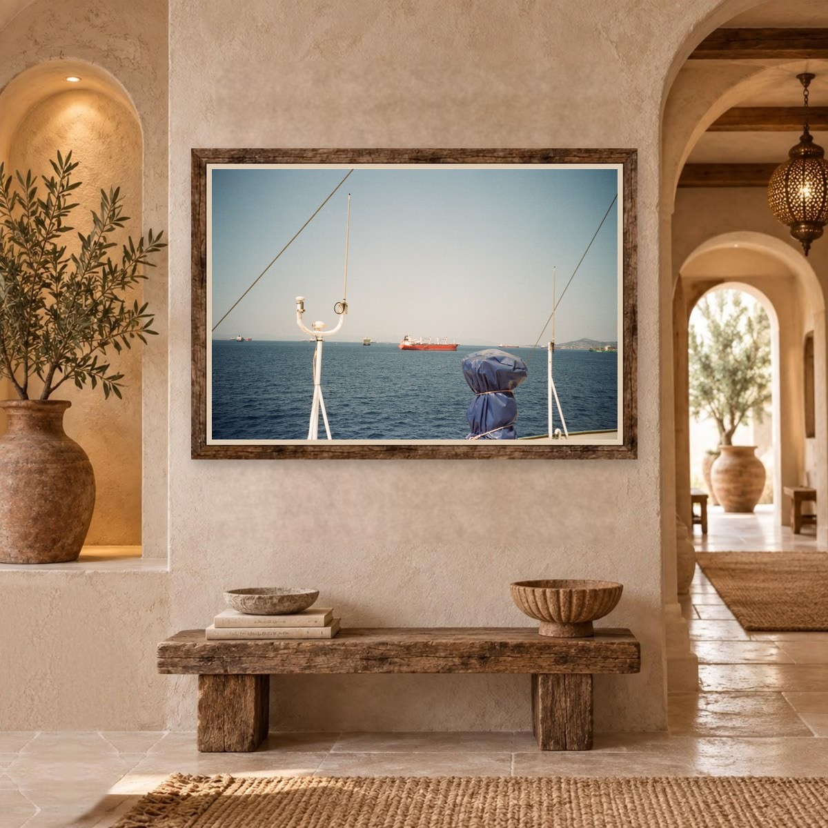 Cargo ships at sea seen past a boat's antenna
